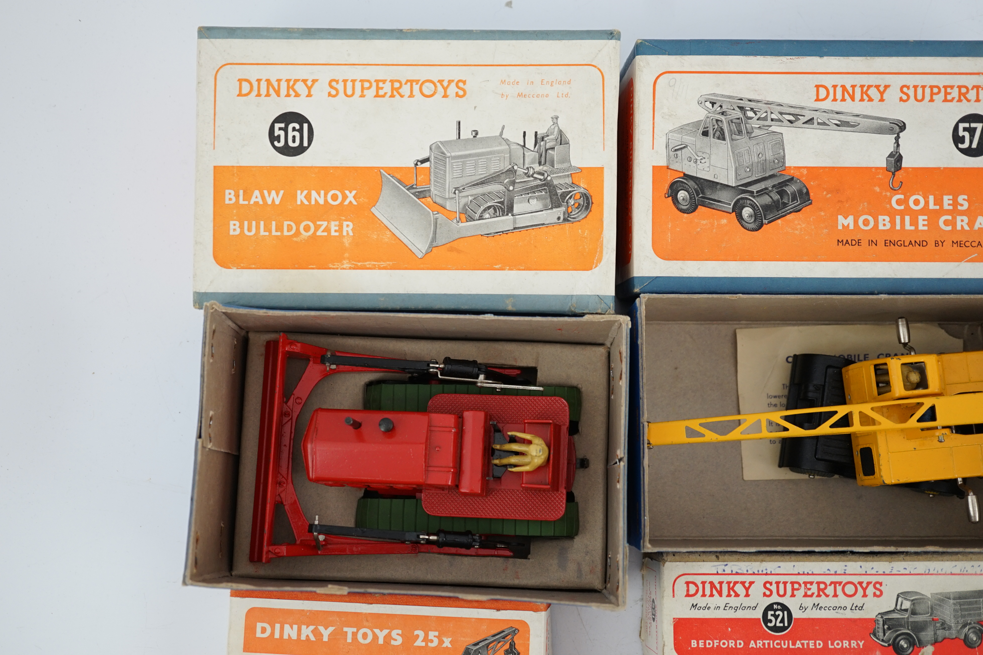 Five boxed Dinky Supertoys and Dinky Toys; a Breakdown Lorry (25x) dark grey with dark blue back, a Bedford Articulated Lorry (521) in yellow, a Blaw Knox Bulldozer (561) In red with green rubber tracks, a Dumper Truck (